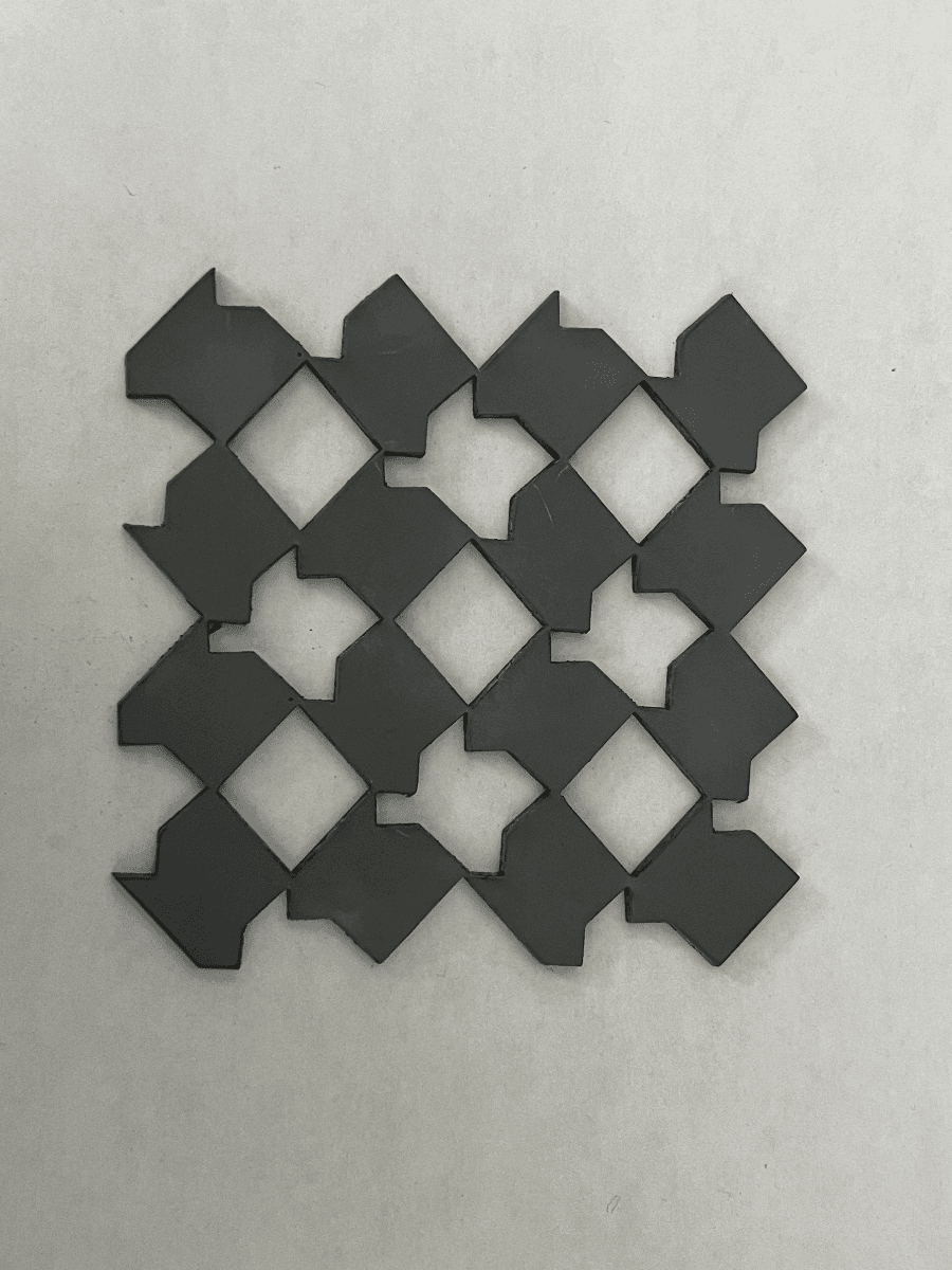 Auxetic wallpaper pattern laser-cut into a silicone rubber sheet, shown in its open state.