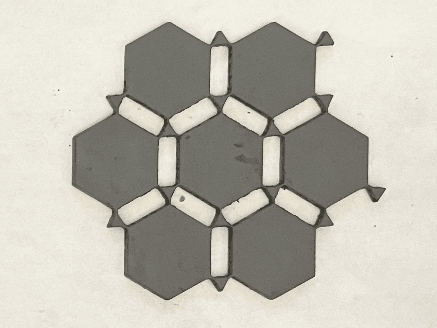 A second wallpaper pattern, cut with rigid inserts between cells to change how the sheet compresses.